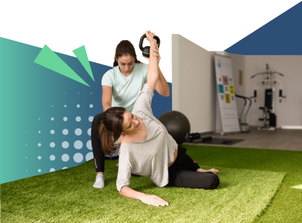 A physical therapist helping a woman stretch